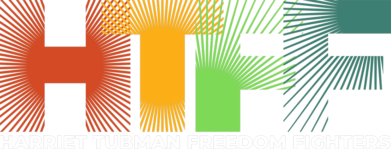 A green and yellow logo with the words " human freedom ".