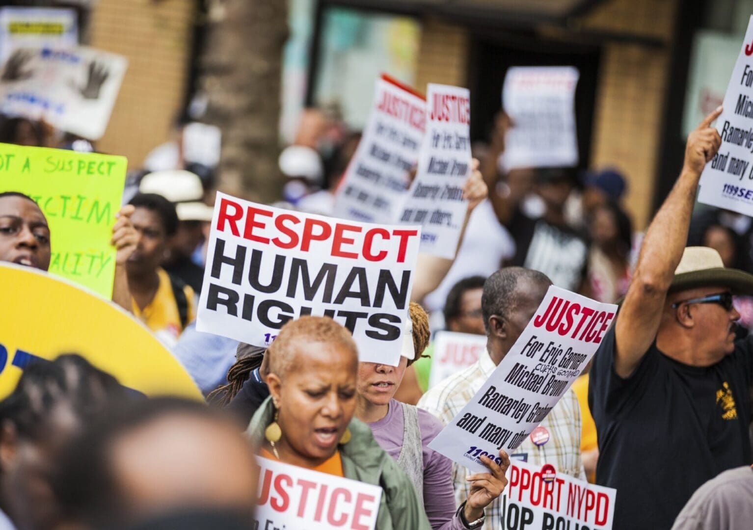 A group of people holding signs that say " respect human rights ".