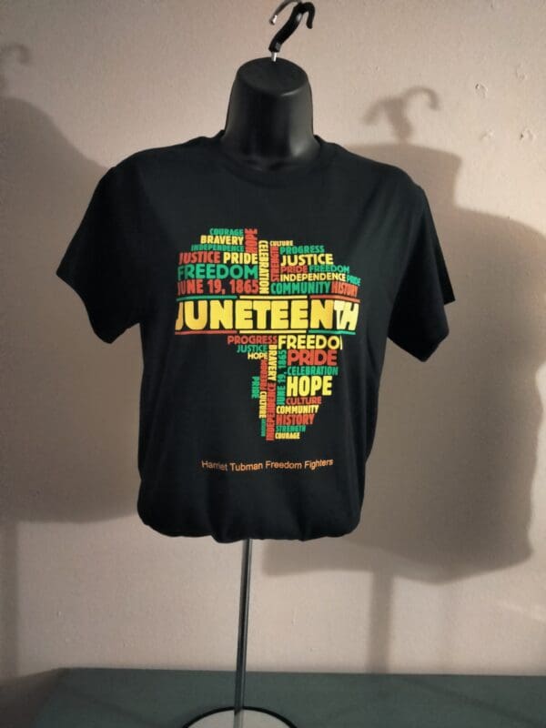 A black t-shirt with the word juneteenth written in different languages.