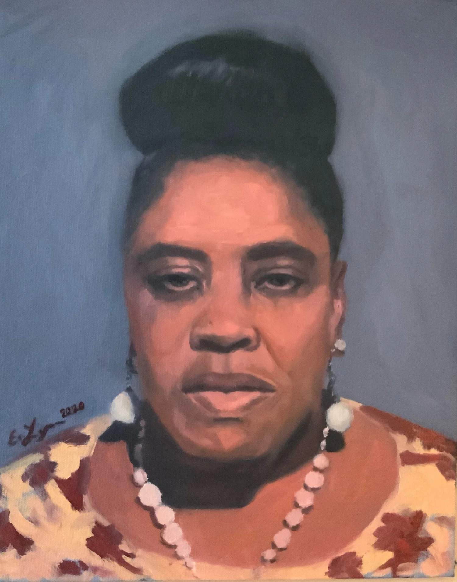 Portrait of a woman with beaded necklace.