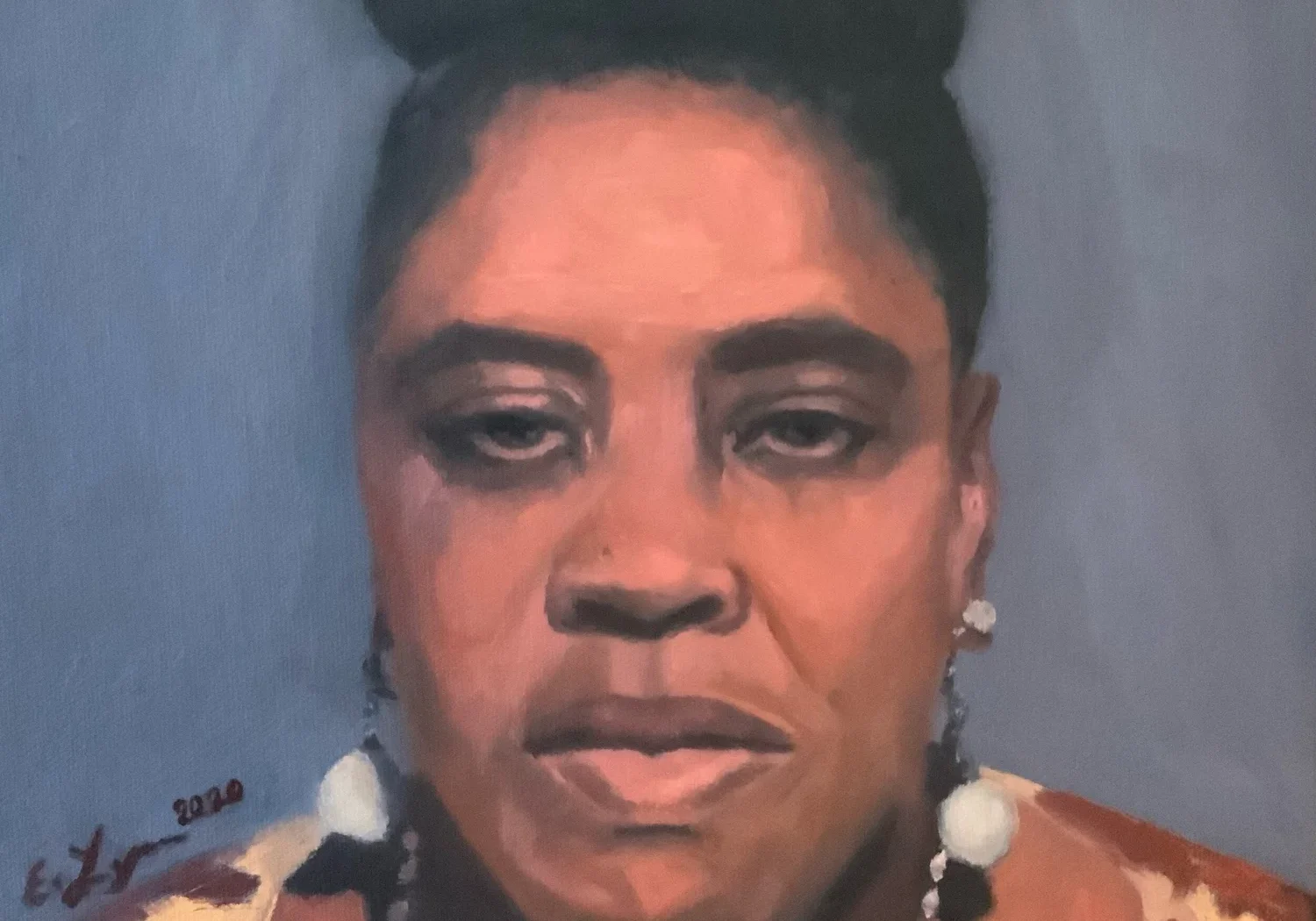 Portrait of a woman with beaded necklace.